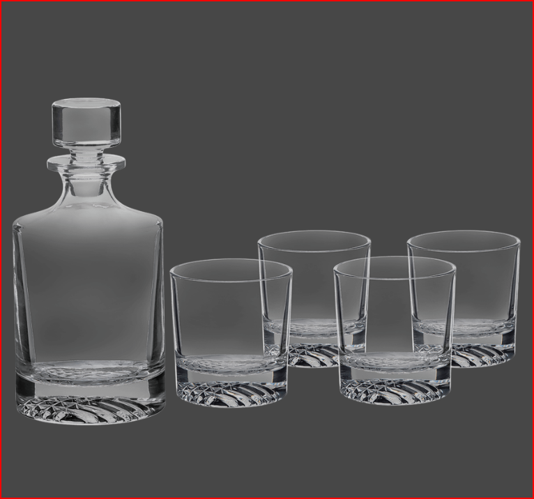 Clear glass decanter and four glasses on a dark gray background